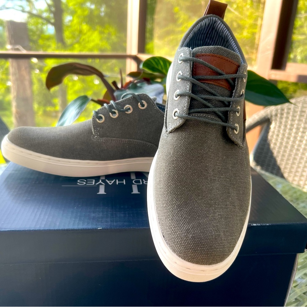 Dark gray, canvas dress sneakers with brown leather detail.